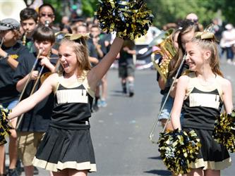 cheer team at parade, girl with pompoms