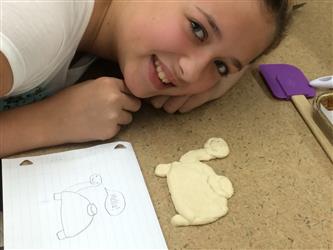 Girl smiling next to cookie