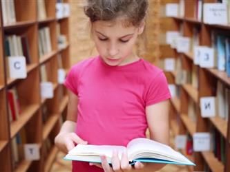 Female student reading in library