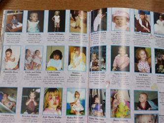 open page of yearbook with baby photos