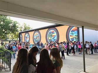 Mural area of school with students gathered