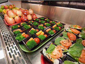 Trays of school lunches with vegetables