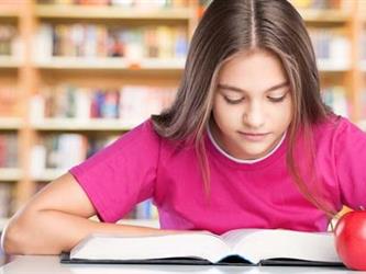 Girl in pink shirt studying book