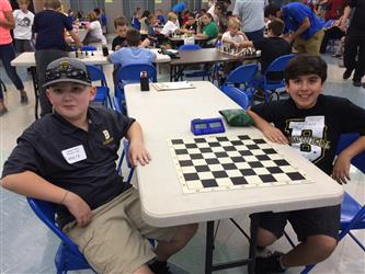 two male students at chess board