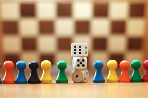 Chess board with dice and colorful pawns