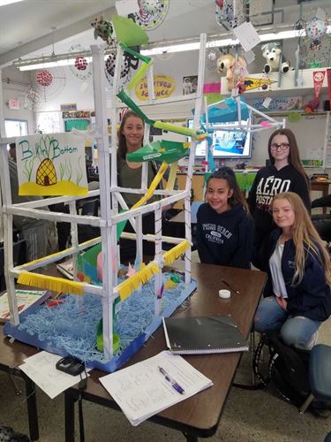 students with handmade miniature roller coaster
