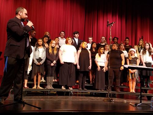 Choir students onstage with choir director