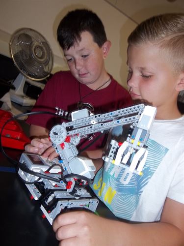 Two boys working on LEGO robot