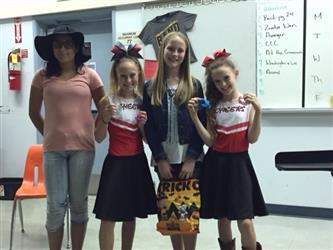 Four students in various costumes